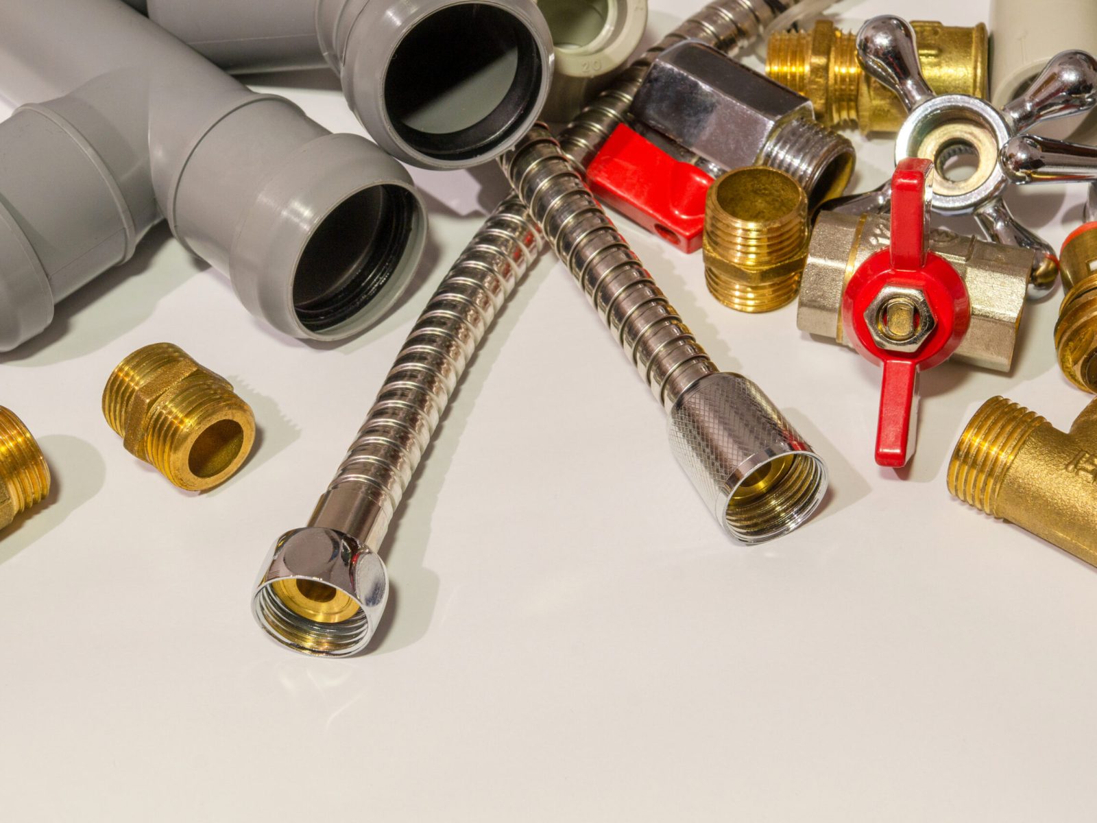 spare parts and accessories for plumbing repair on a gray background